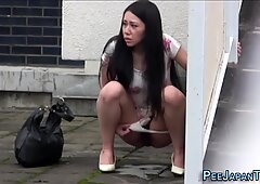 Embarrassed asian peeing