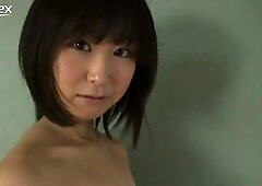 Whorish Japanese gal Yumi Ishikaw poses on a cam wearing ripped off top